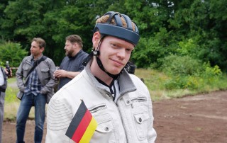 Ein Nutzer der Lebenshilfe Neuss mit einem Kopfschutz und einer kleinen Deutschlandfahne aus Papier.