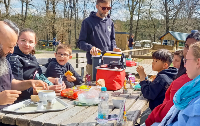 Gruppe von Kindern und Betreuern der Lebenshilfe Neuss bei Pause im Wildpark Eifel.