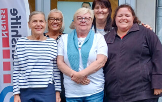 Eine Gruppe Mitarbeiterinnen der Lebenshilfe Neuss steht beim Sommernachtslauf 2025 vor dem Lebenshilfe Center.