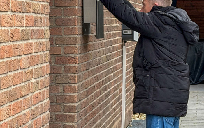 Ein Bewohner wirft ein Heft in den Briefkasten.