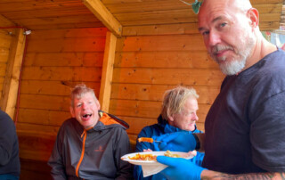 Die Bewohner und Betreuer essen zusammen.
